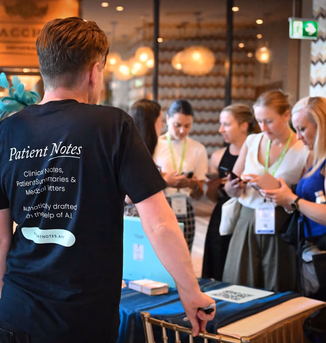 A man wearing a black shirt with the words patient notes on it.