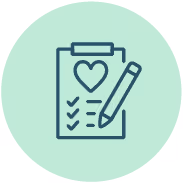 A green heart on a notepad and a pencil.
